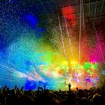 people watching concert with multicolored stage light display